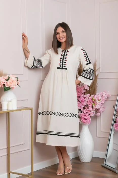 Rochie traditionala crem cu model floral negru Delia